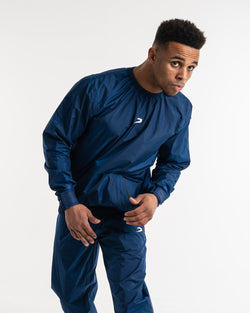 Man in a navy sauna suit tracksuit with a white boxraw logo on the chest as well as adjustable wrist straps and made from polyester.